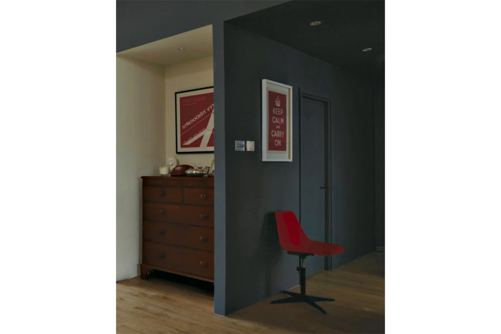 A hallway can be an excellent place for a splash of dark paint as you transition out of the busier rooms of the house. (Courtesy of Farrow & Ball)
