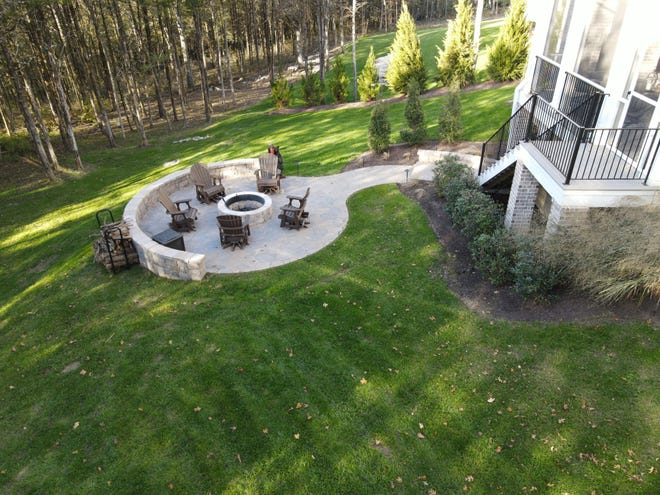 The backyard is being dubbed the "new family room" since the pandemic forced so many families to entertain at home. This fire pit is a great example of how a homeowner reimagined their backyard space to become a gathering place.